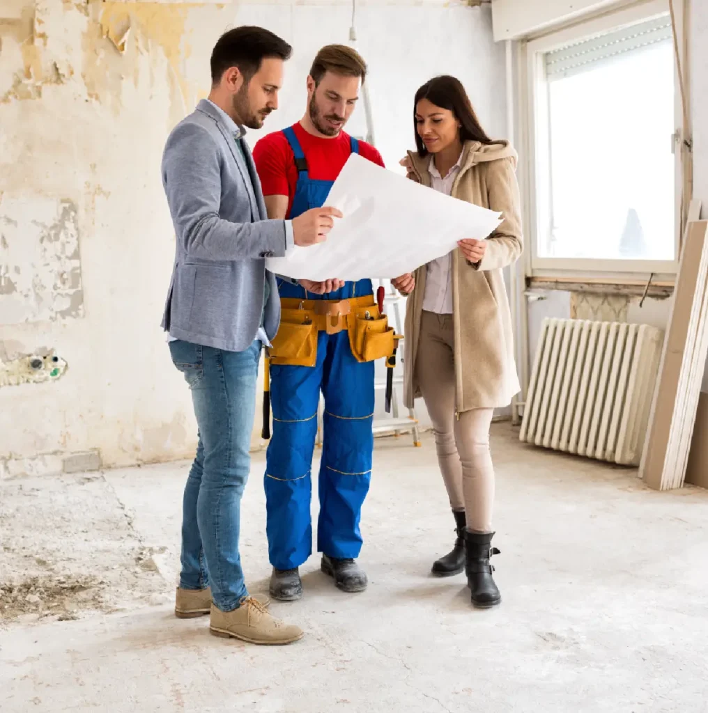 A group of people standing around looking at plans.