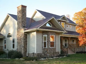 A large house with a brick chimney and stone front.