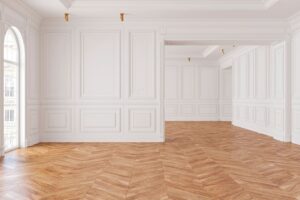 A room with white walls and wooden floors.