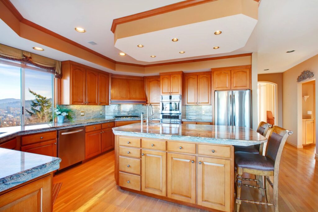 Spacious kitchen with wooden cabinets and island.