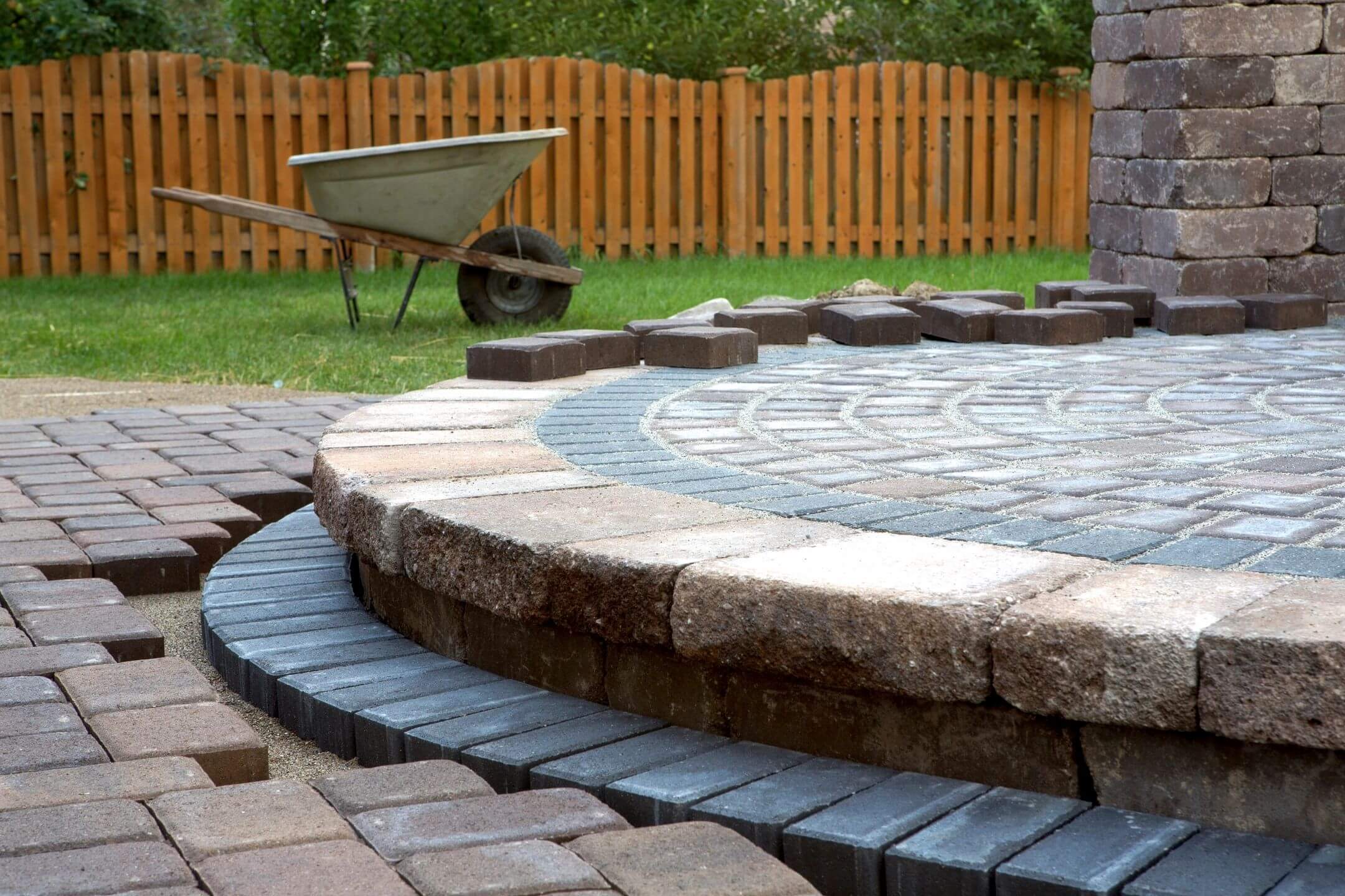 A brick patio with a circular design in the middle of it.